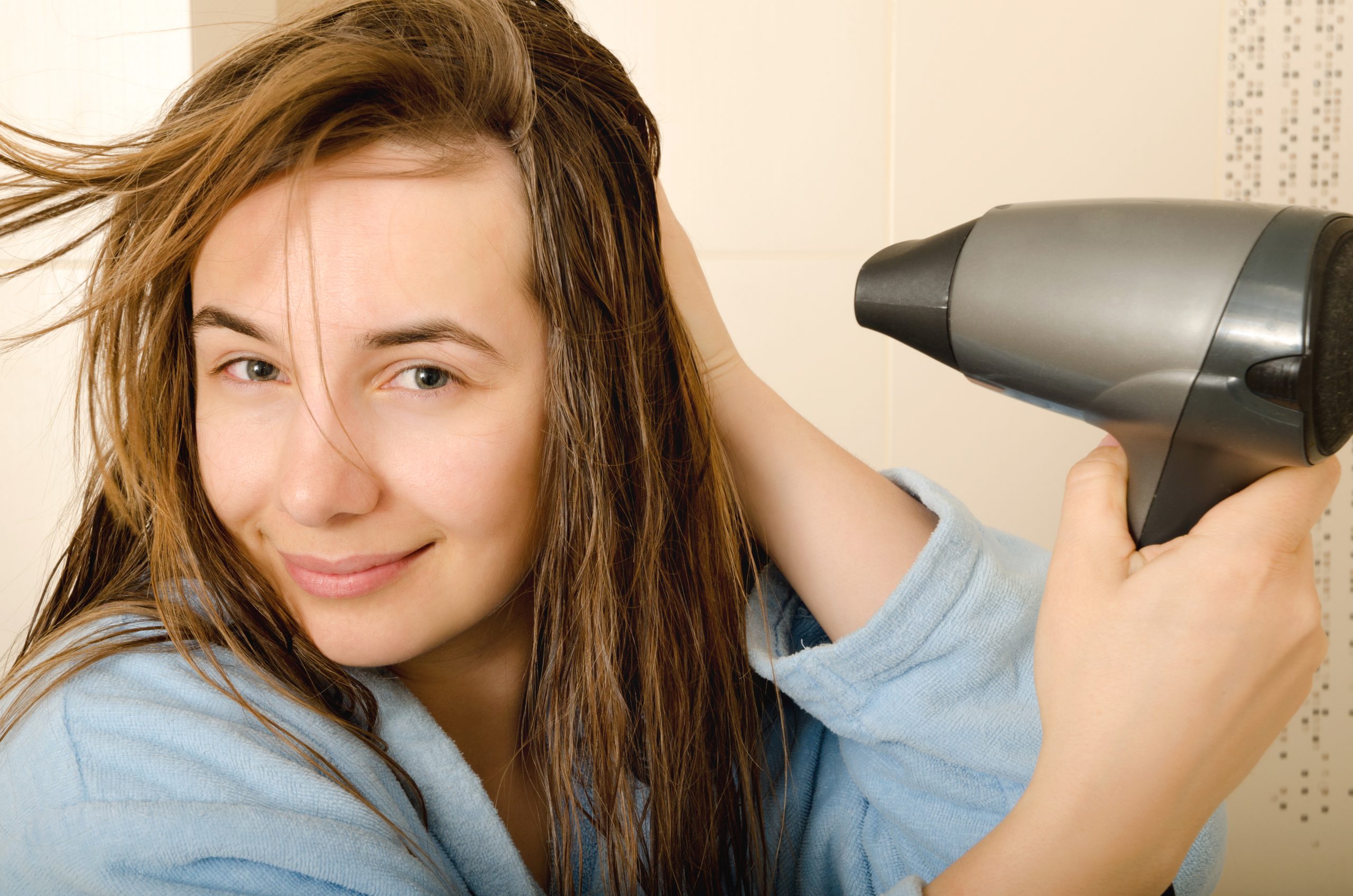 Air drying hair naturally for healthier, shinier locks.