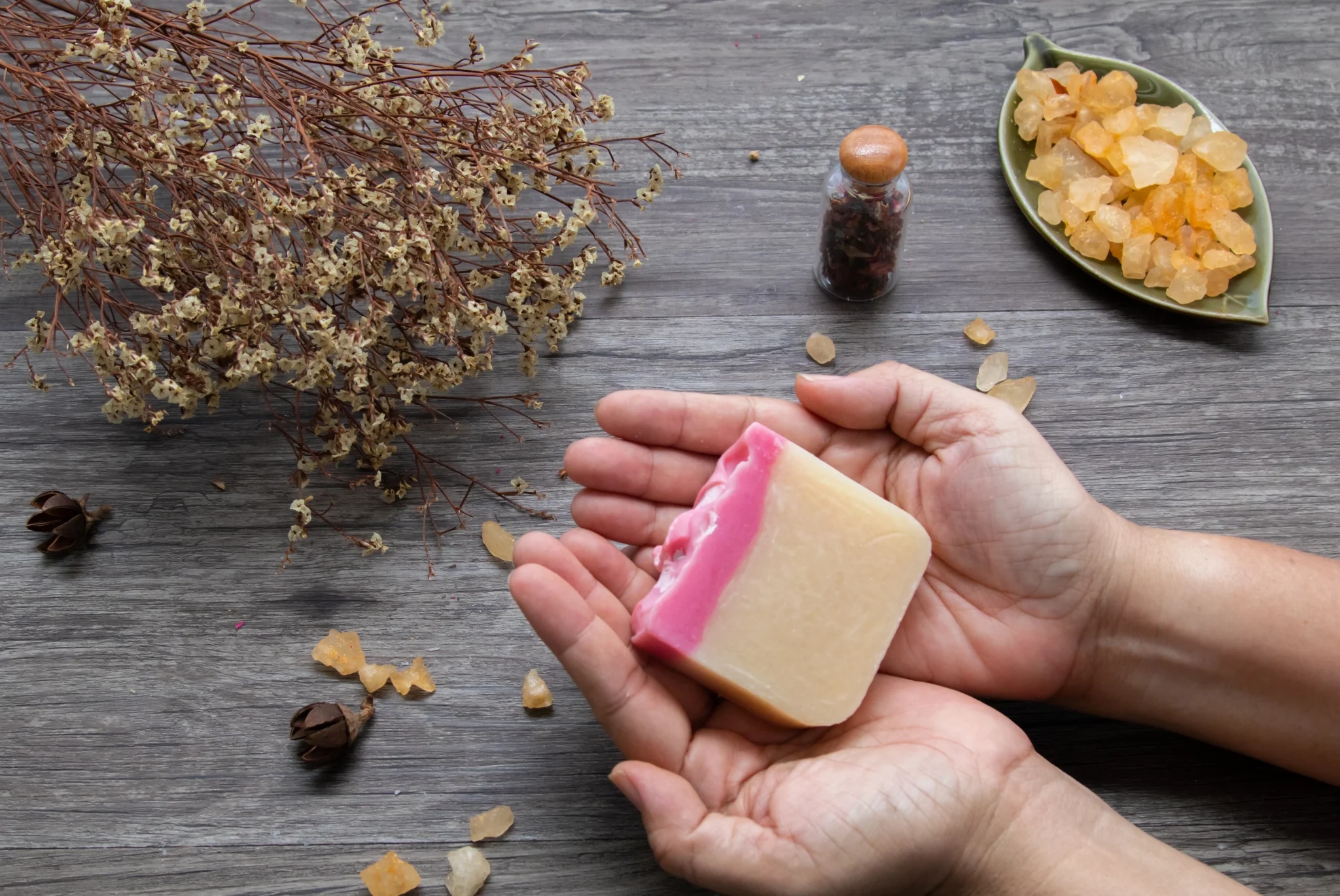 Handmade pink and beige Castile soap bar for feminine hygiene with natural herbs and resin
