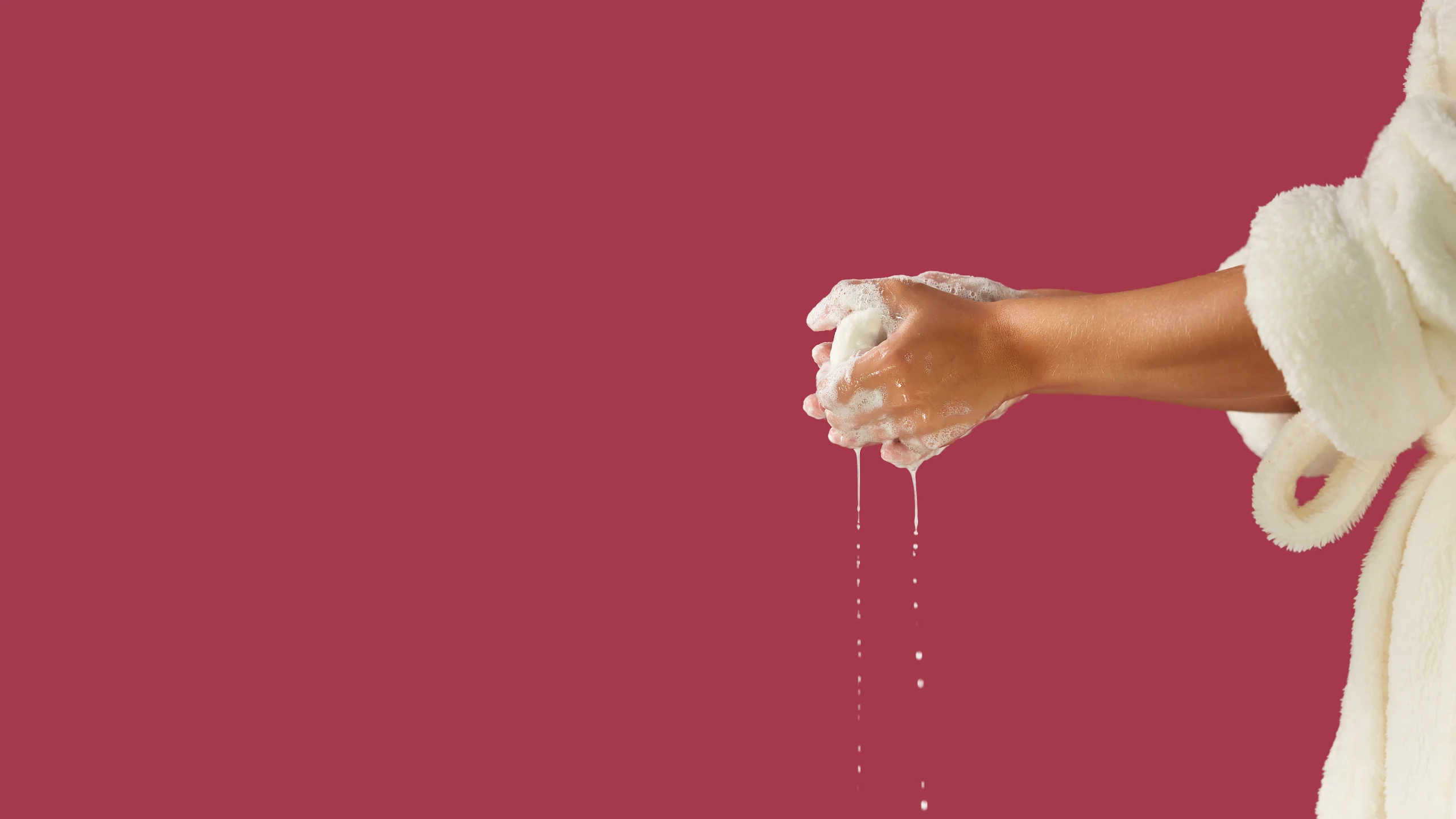 Woman lathering Castile soap in hands with foam and water for feminine hygiene cleansing