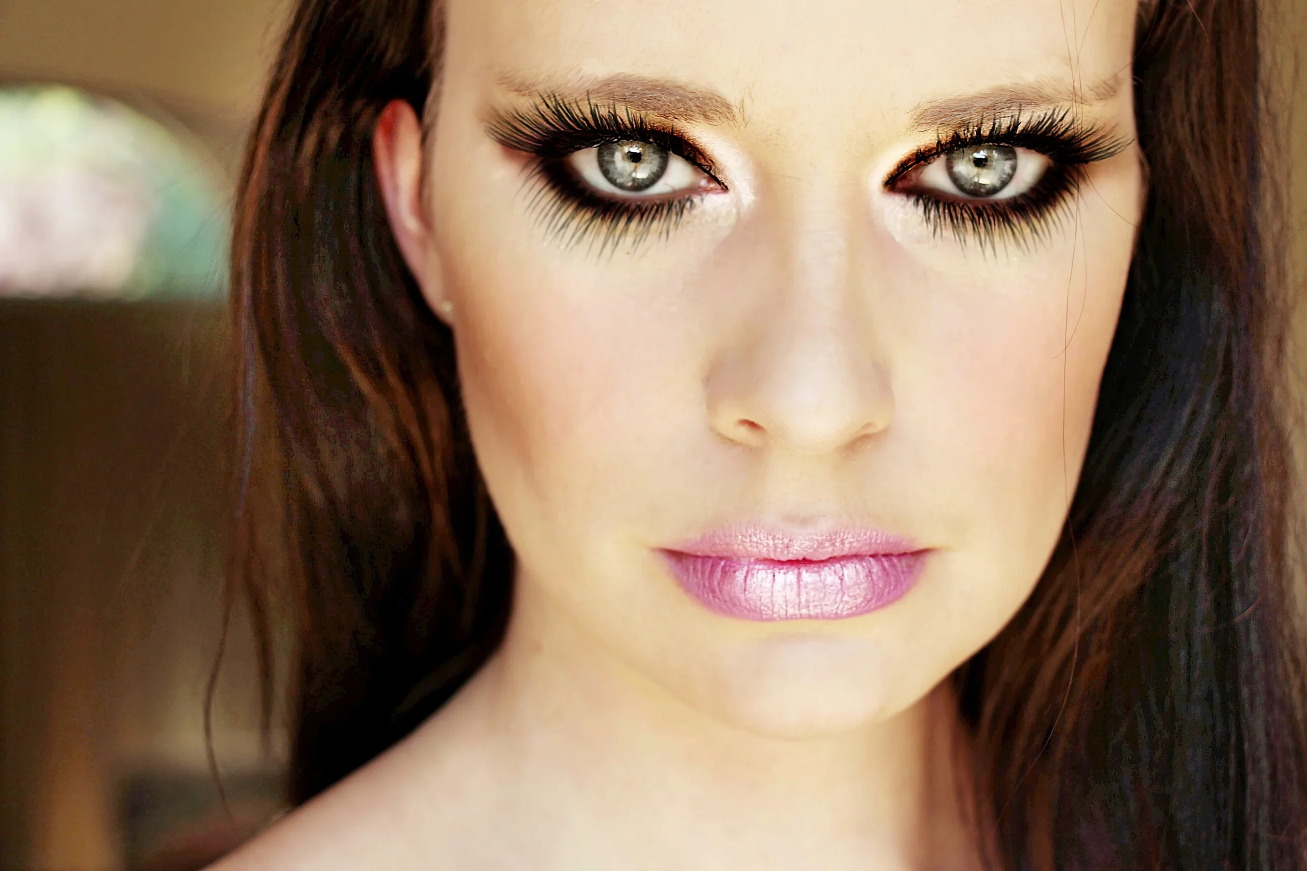 False eyelashes applied without any eye makeup for a clean, natural appearance.