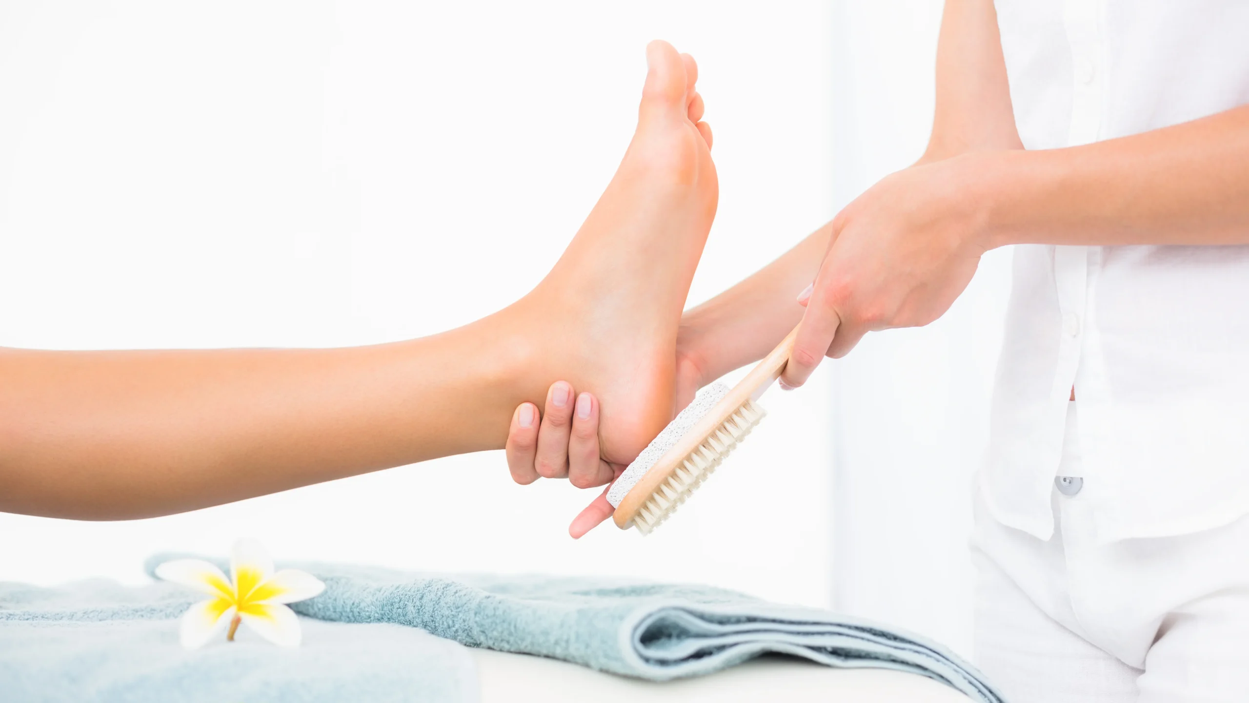 DIY natural foot scrub with sugar and coconut oil applied on feet