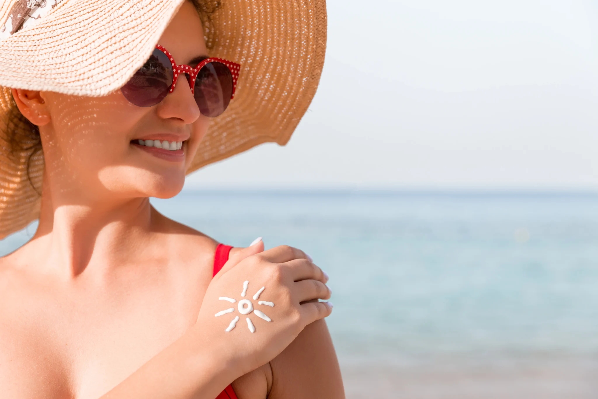 Woman using cooling after sun face mist for instant skin relief.