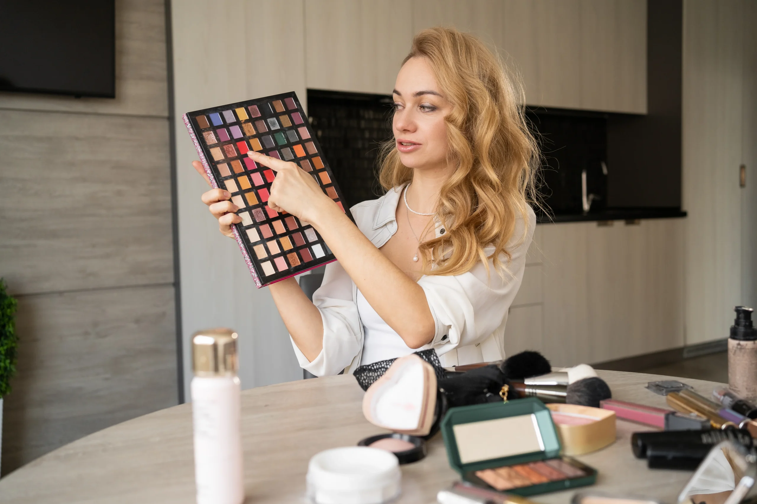 Women of varying skin tones using peach and orange correctors for dark spots.