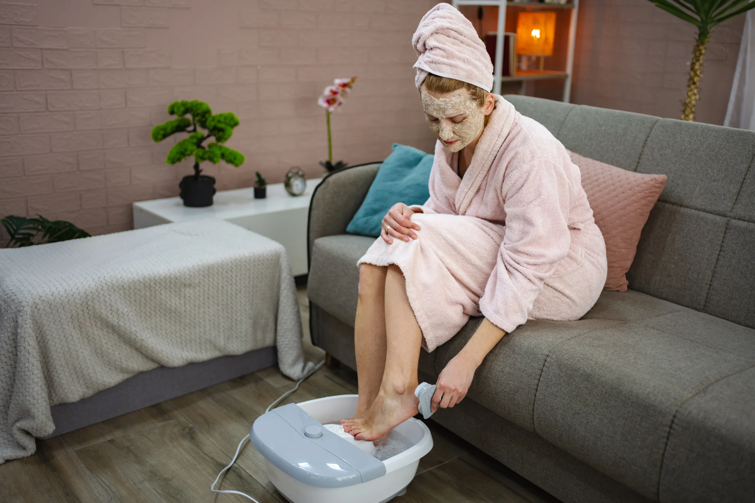 Applying moisturizer during a home pedicure routine.