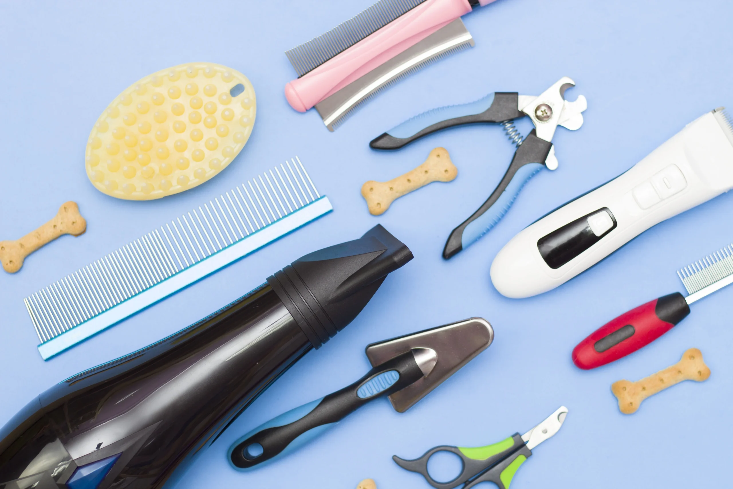 Professional grooming tools including clippers, razors, and styling products on a counter.