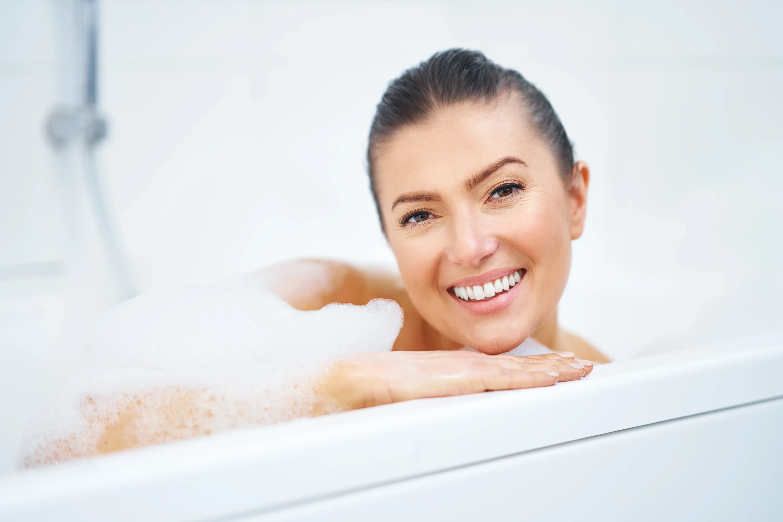 Spa scene with anti-aging body wash and body care products for glowing skin.