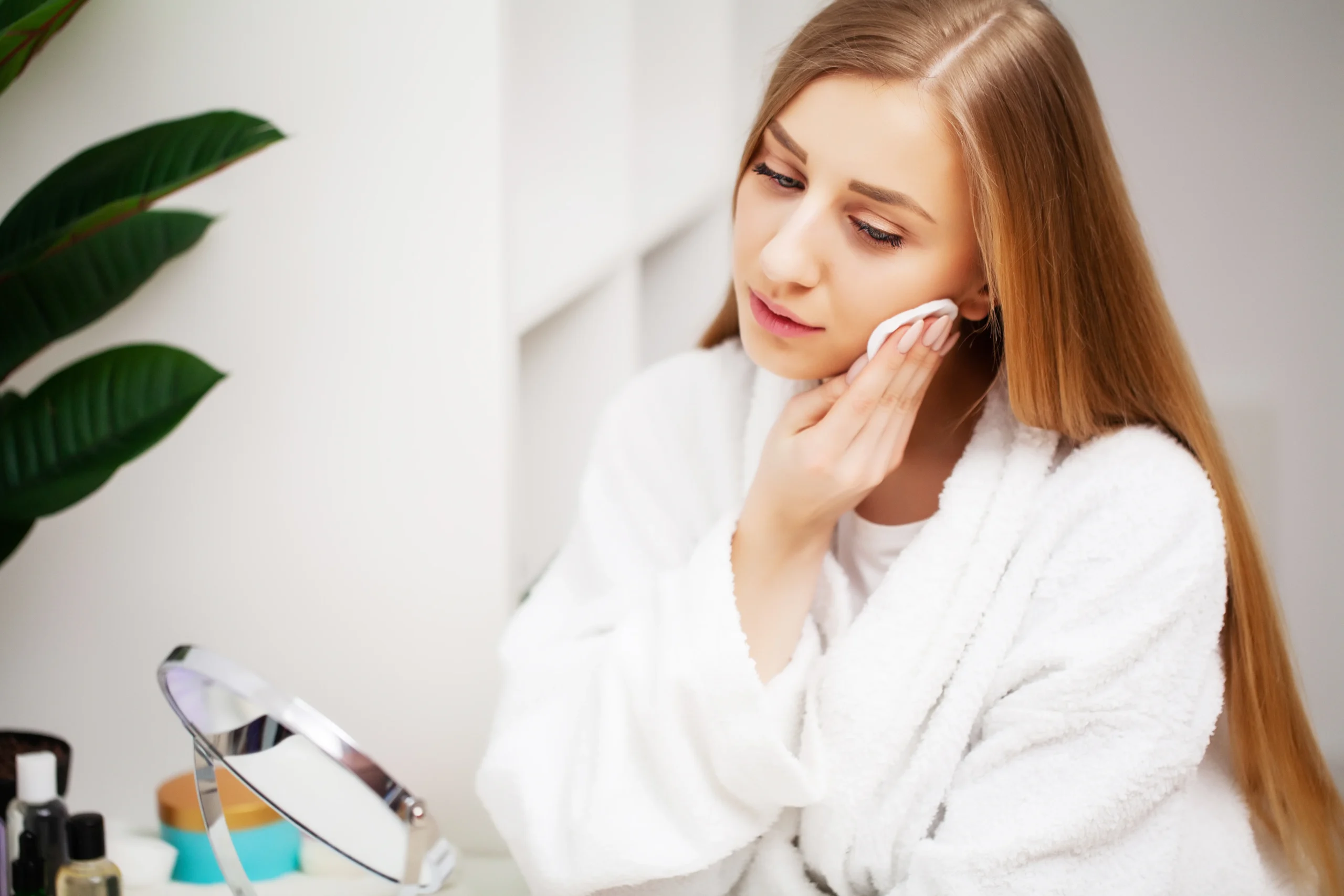 Woman cleansing face with foaming gel cleanser as part of best face care for oily skin morning routine.