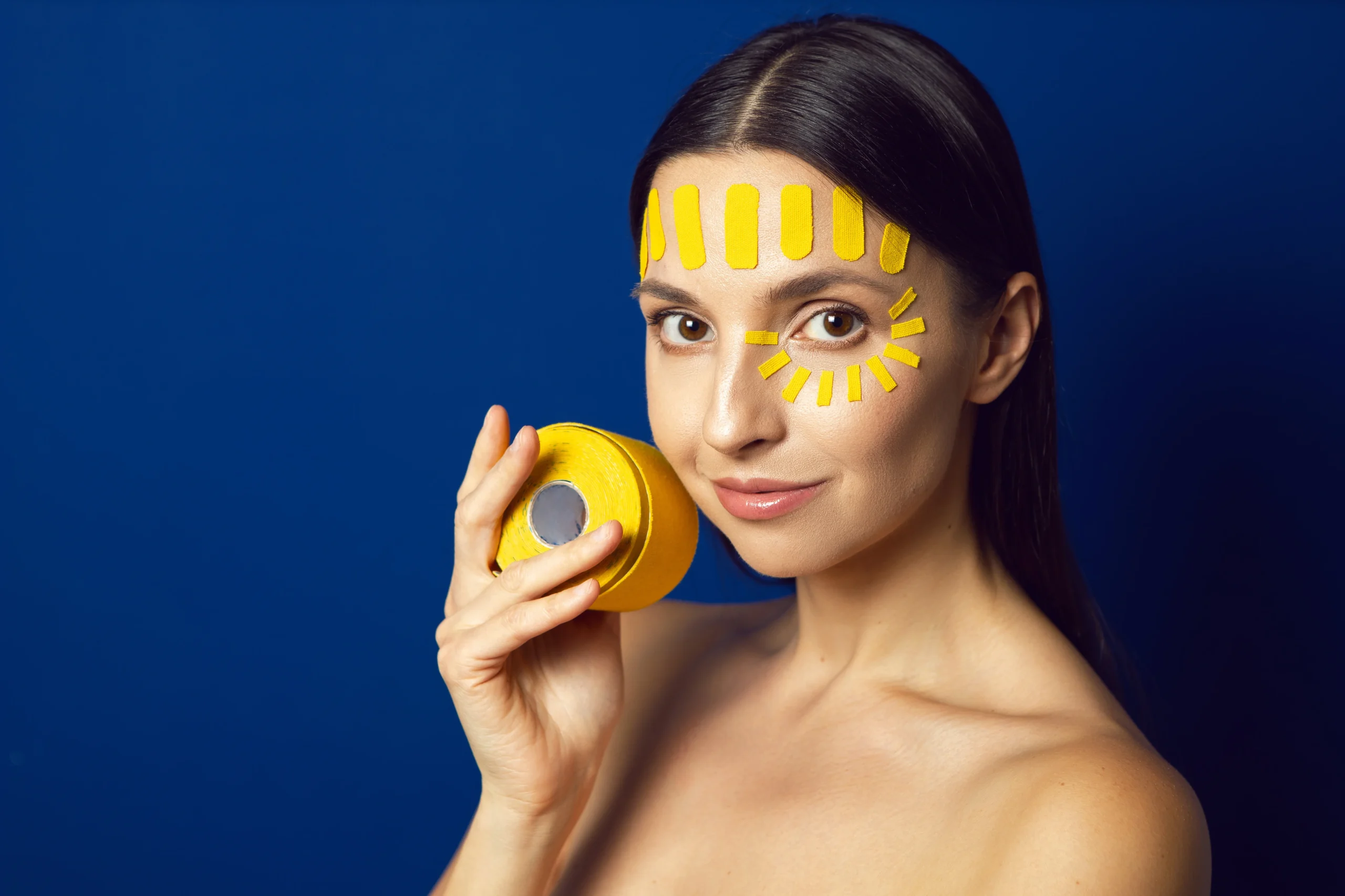 Applying sunscreen to prevent sun spots and protect from UV damage.