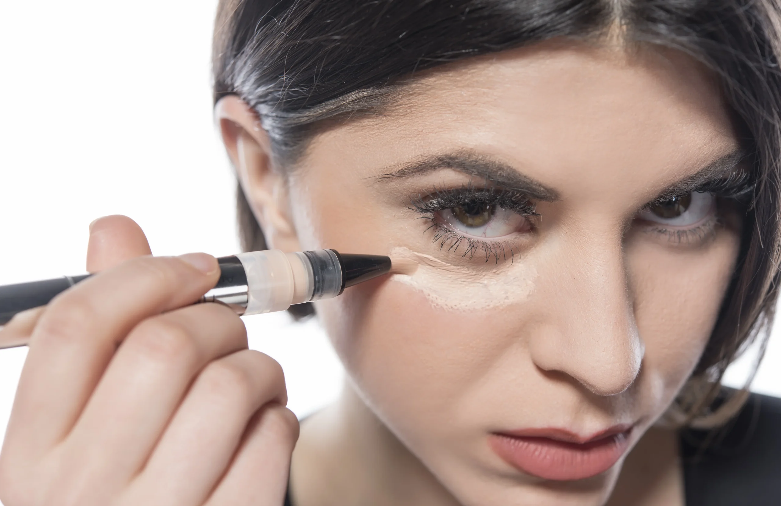 Peach corrector applied under eye for how to cover a black eye with makeup naturally.