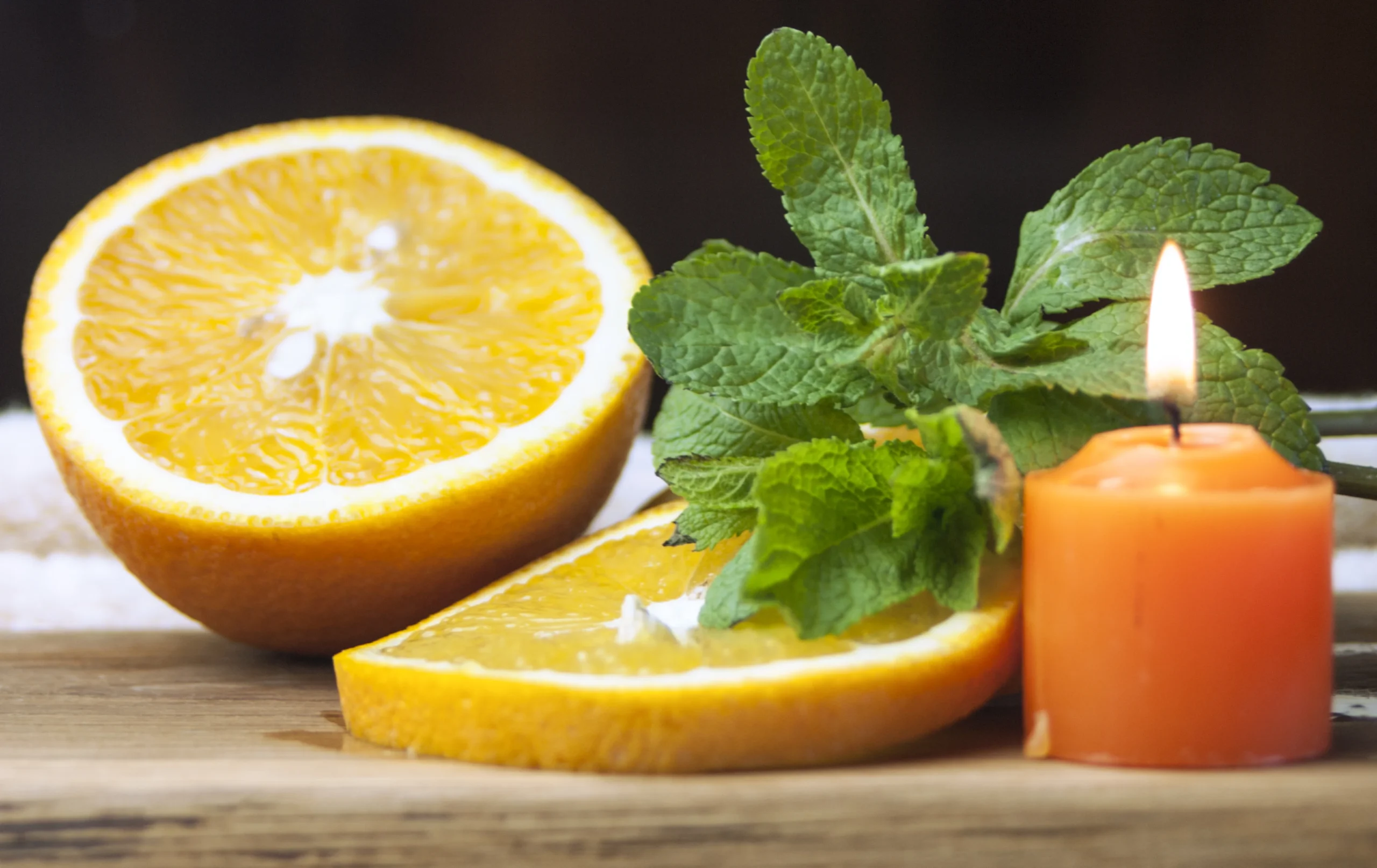 Jo Malone Lime Basil & Mandarin cologne surrounded by citrus fruits and basil leaves